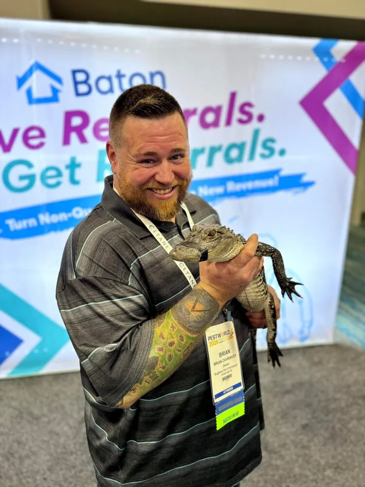 Brian at the 2025 PestWorld industry conference holding a young alligator