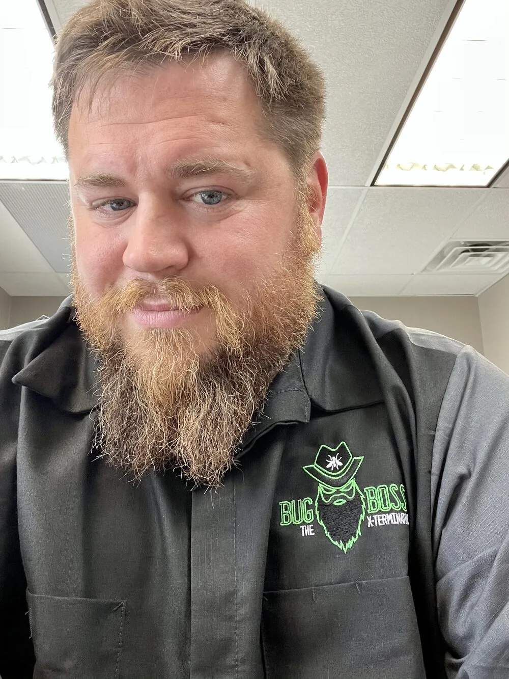 Brian Zahringer, owner of BugBoss The X-Terminator, in a branded BugBoss work shirt