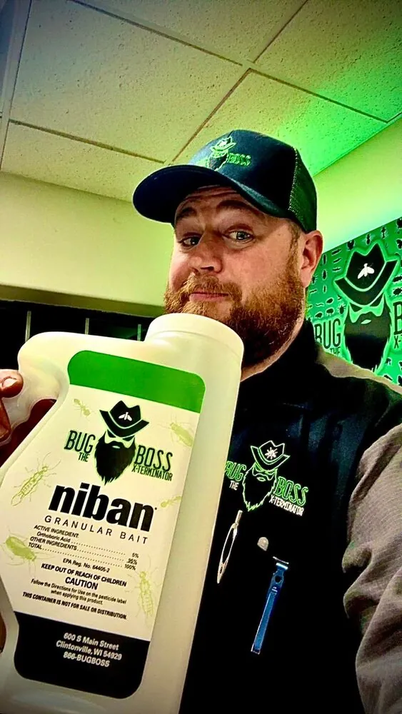 Brian holding a bottle of BugBoss-labeled Niban granular bait in the Clintonville office