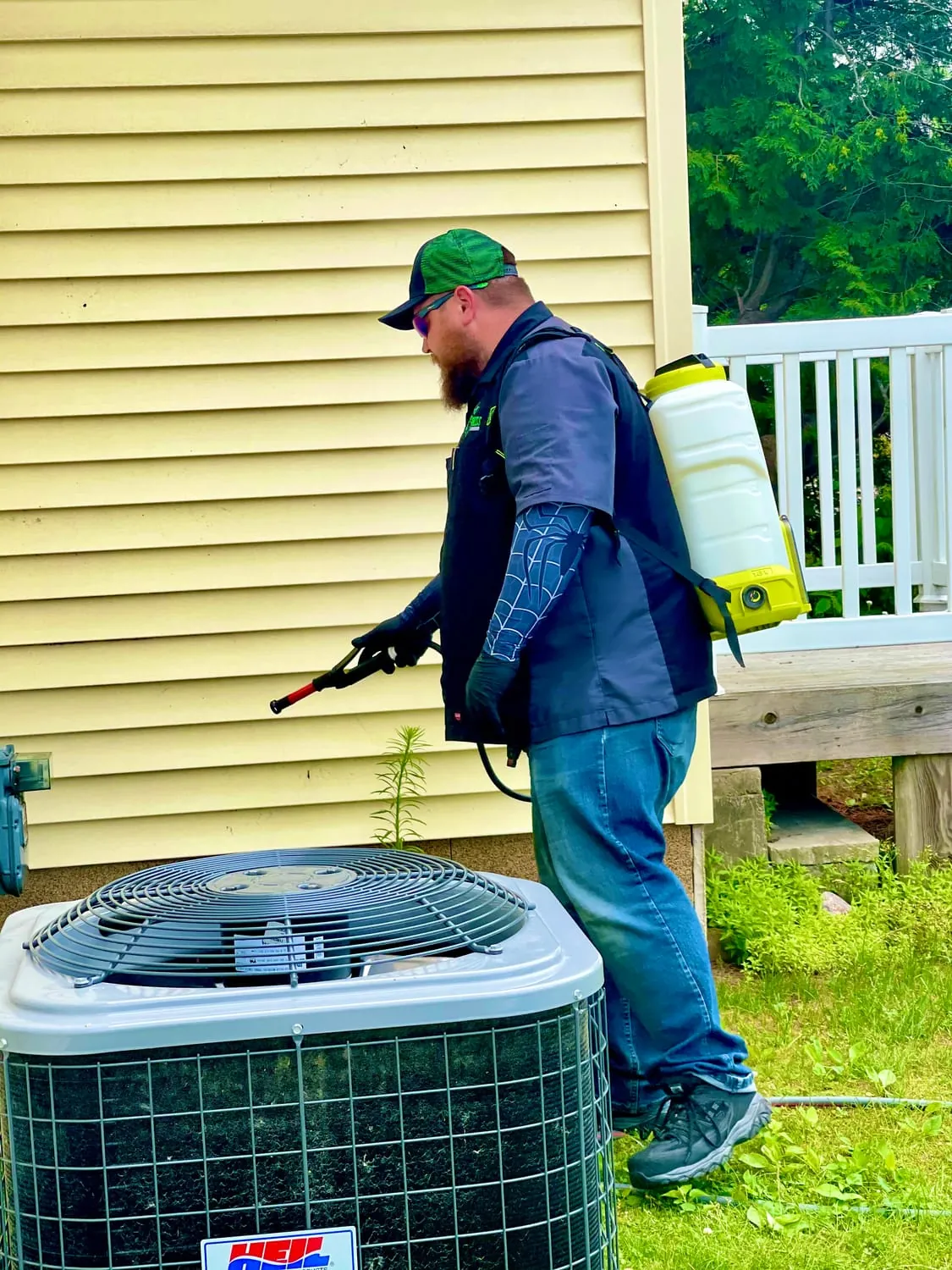 BugBoss treating the exterior of a home and yard edge