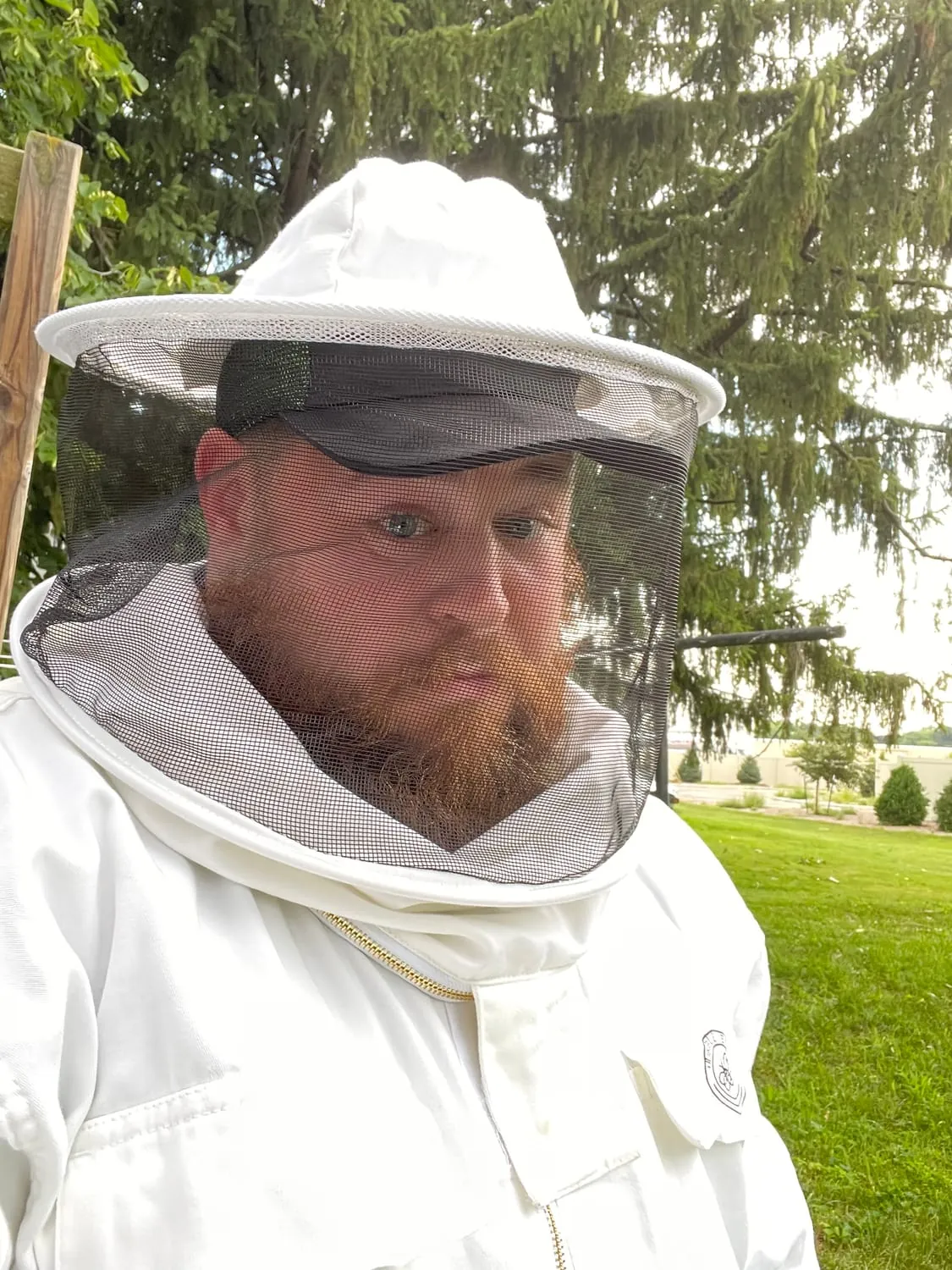 BugBoss owner suited up in a bee veil for a stinging-insect job
